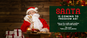 Santa in a red suit sits beside gift boxes and cookies, smiling warmly. A sign reads "Santa is coming to Freedom AG!" with invitation details. Cozy, festive mood.